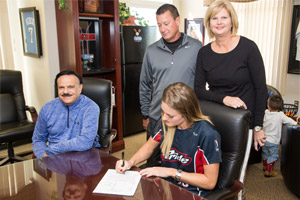 Hannah Rogers signing her NPF contract with Pride GM Don DeDonatis and her parents Rhonda and Tim